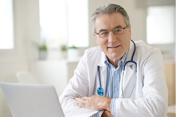 Compassion MD application login screen on a laptop