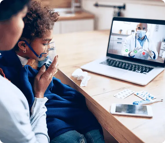 Parent and child having an online doctor consultation via laptop at home